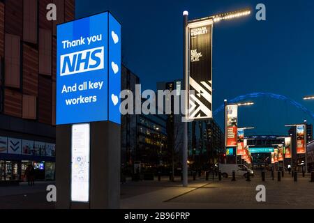 Wembley Park, London, UK. 23rd Mar 2020. The UK Adjusts To Life Under The Coronavirus Pandemic Wembley Park shows appreciation to the NHS and its frontline staff with illuminated 'Thank you NHS' signs Credit: Chris Aubrey/Alamy Live News Stock Photo