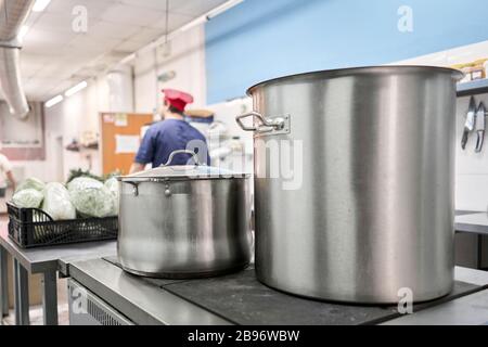 Cook with big cooking pot in the kitchen Stock Photo - Alamy