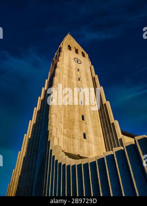 Upwards shot of bell tower of famous Hallgrimskirkja in Reykjavik, Iceland. Great architecture in front of clear blue sky on sunny day. No people visi Stock Photo