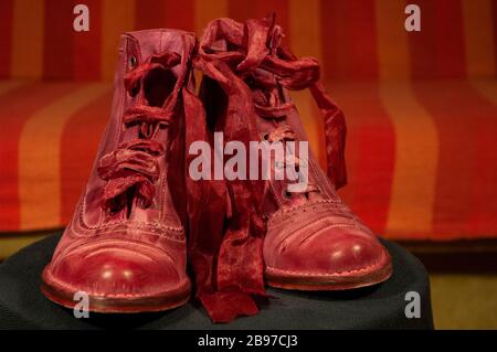 Red boots with silk laces and orange  stripe background Stock Photo