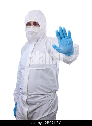 male epidemiologist in coverall disposable anti-epidemic antibacterial isolation suit shows prohibitory gesture with one hand isolated on white backgr Stock Photo