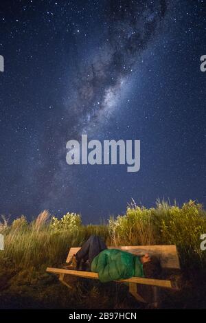 Man stargazing beneath the milky way in Turangi, New Zealand Stock Photo