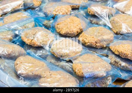 Vegan rissoles (fasirozott fasirt) wrapped in plastic bags ready to be deep-frozen Stock Photo