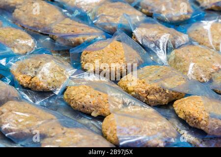 Vegan rissoles (fasirozott fasirt) wrapped in plastic bags ready to be deep-frozen Stock Photo