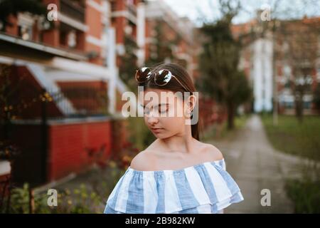 A beautiful young caucasian girl with a pink notebook in the park Stock Photo