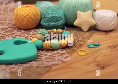 crochet wood and blue and yellow silicon rattle Stock Photo