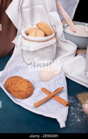 Jar of biscuits and flour on table Stock Photo