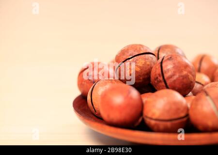 Macadamia nuts on a wooden background Stock Photo
