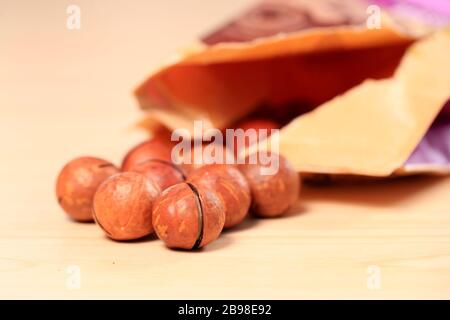 Macadamia nuts on a wooden background Stock Photo