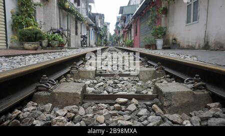 rusty railroad tracks in hanois famous train street Stock Photo