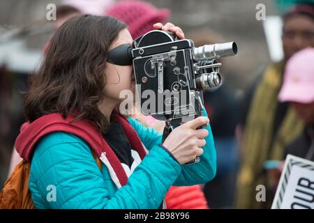 Woman taking video with vintage camera Stock Photo