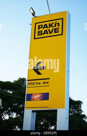 Yellow and black sign for  Pak'nSave discount supermarket against blue sky in Auckland, New Zealand. Stock Photo
