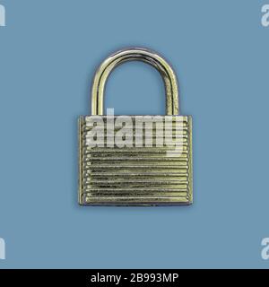 A closed golden padlock on a blue background Stock Photo