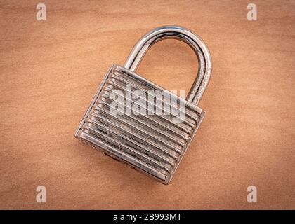 A closed padlock on a wooden surface Stock Photo