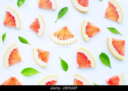 High vitamin C. Juicy grapefruit slices with leaves on white background. Stock Photo
