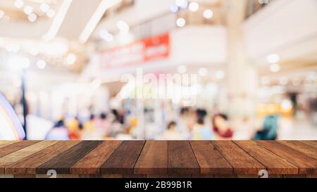 Empty wood table and blurred light table in shopping mall with bokeh background. product display template. Stock Photo