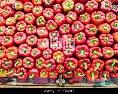 Red bell peppers on display in a supermarket Stock Photo