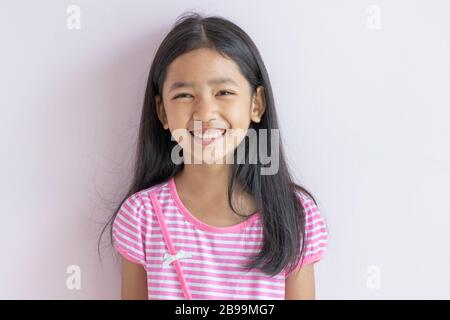 Asian teen daughter smile happily as reconcile with her adopted ...