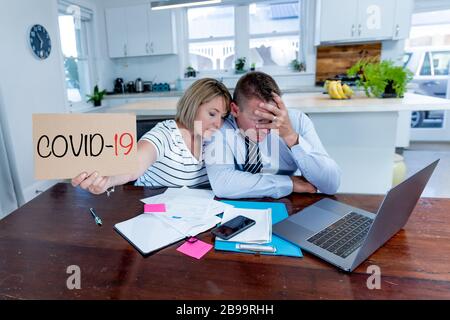 Coronavirus economic recession. Family couple in distress of job losses worried about bills, credit debts, loans and home finances. Impact of COVID-19 Stock Photo