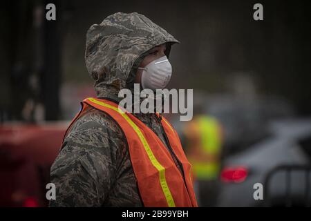 Holmdel, United States. 23rd Mar, 2020. A New Jersey National Guard Airman directs traffic at a COVID-19 Community-Based Testing Site at the PNC Bank Arts Center in Holmdel, N.J., on March 23, 2020. The testing site, established in partnership with the Federal Emergency Management Agency, is staffed by the New Jersey Department of Health, the New Jersey State Police, and the New Jersey National Guard. Photo by Master Sgt. Matt Hecht/U.S. Air National Guard/UPI Credit: UPI/Alamy Live News Stock Photo