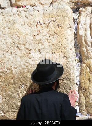 A Jewish man praying by the wailing wall in the old city of Jerusalem. Stock Photo