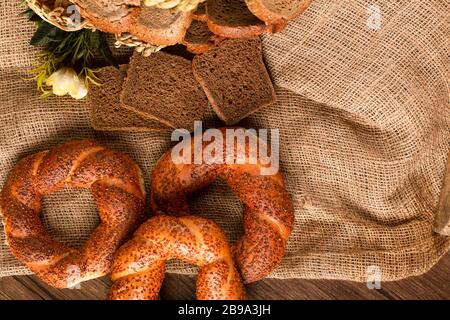 Bagel and slices of dark bread in basket Stock Photo