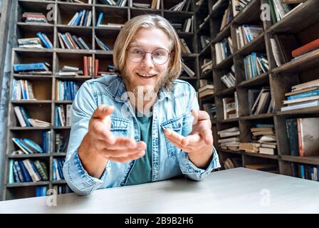 Young happy bearded student blogger look point at camera. Stock Photo