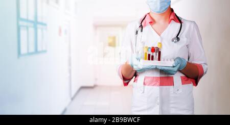 Doctor holding tray with blood tubes Stock Photo