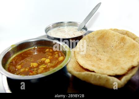 Indian dish spicy Chick Peas curry also known as Chola/Chana Masala or commonly Chole, served served with fried puri Stock Photo