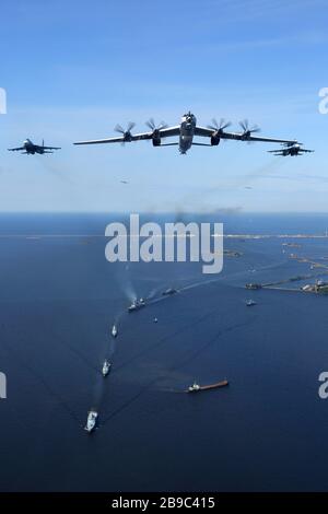 Tu-142MZ airplane in formation with Su-33 jet fighters of the Russian Navy. Stock Photo