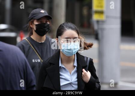 SYDNEY, AUSTRALIA, 24 Mar 2020, Two young women wearing surgical face masks are seen in the streets of Sydney’s CBD following the government’s response to the coronavirus outbreak to close non-essential businesses and limit physical contact between people. Credit: Sebastian Reategui/Alamy Live News Stock Photo