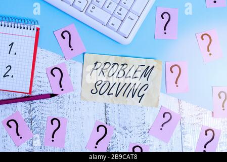 Writing note showing Problem Solving. Business concept for process of finding solutions to difficult or complex issues Writing tools and scribbled pap Stock Photo