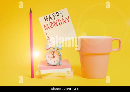 Word writing text Happy Monday. Business photo showcasing telling that demonstrating order to wish him great new week Alarm clock coffee cup note stac Stock Photo