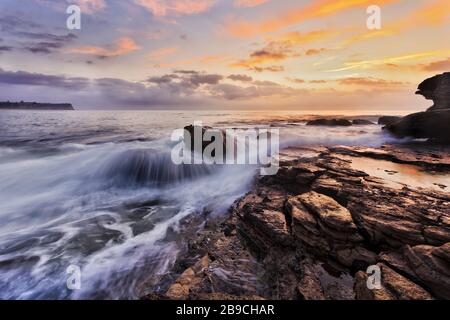 Scenic sunrise on Pacific ocean coast of Sydney Northern beaches off Turimetta head.