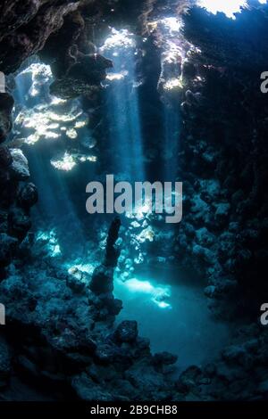 Sunbeams penetrate the cave entrance from above, Red Sea. Stock Photo