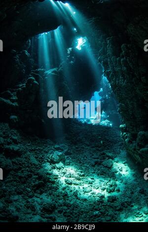 Sunbeams pour down through the ceiling of this cavern, Red Sea. Stock Photo