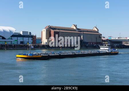 Mannheim, Germany; March/23/2020;  Barges transporting goods in bulk along the Rhine river to the pass through Mannheim city. Stock Photo