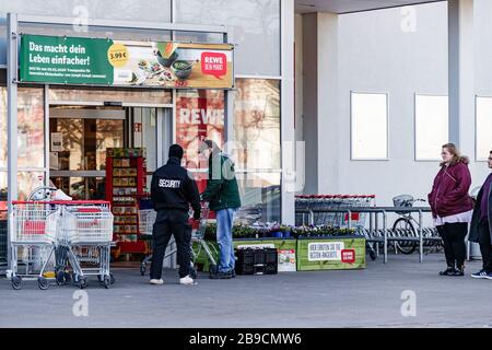 Berlin, Germany. 23rd Mar, 2020. Customers queue to enter a supermarket in Berlin, capital of Germany, March 23, 2020. The German government has approved the 'largest aid package' in the country's history to combat the coronavirus, the Ministry of Finance (BMF) announced on Monday. Credit: Binh Truong/Xinhua/Alamy Live News Stock Photo