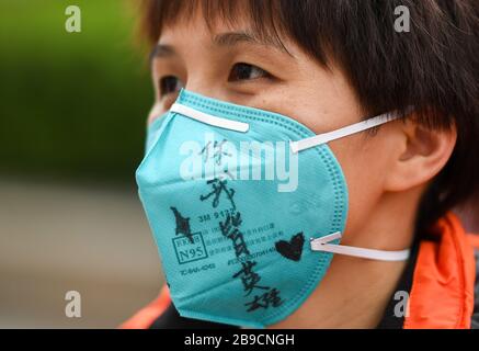 (200324) -- WUHAN, March 24, 2020 (Xinhua) -- Handwritten farewell words are seen on the face mask of Zhang Qiuping, a medical worker from Guangdong Province, before her departure in Wuhan, central China's Hubei Province, March 23, 2020.  The 14th batch of medical workers from Guangdong Province left Wuhan on Monday after finishing their task. (Xinhua/Chen Yehua) Stock Photo