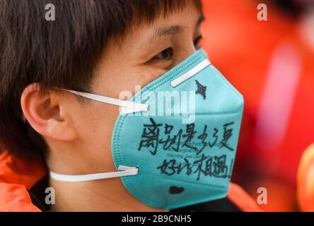 (200324) -- WUHAN, March 24, 2020 (Xinhua) -- Handwritten farewell words are seen on the face mask of Zhang Qiuping, a medical worker from Guangdong Province, before her departure in Wuhan, central China's Hubei Province, March 23, 2020.  The 14th batch of medical workers from Guangdong Province left Wuhan on Monday after finishing their task. (Xinhua/Chen Yehua) Stock Photo