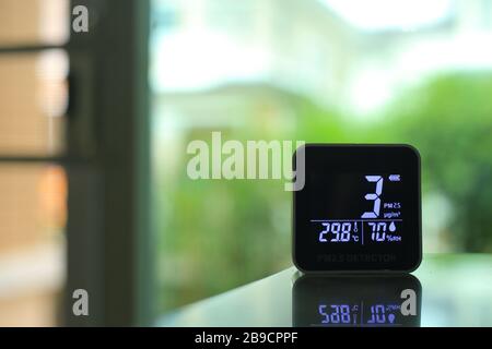 air quality sensor placing on a table indoor. sensor found small amount of air pollution of PM 2.5 the poisonous harmful particulate matter invisible Stock Photo