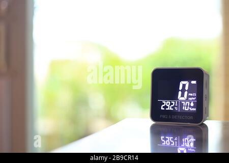 air quality sensor placing on a table indoor. sensor found small amount of air pollution of PM 2.5 the poisonous harmful particulate matter invisible Stock Photo