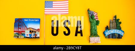 word USA with magnets from new york and san francisco on yellow background, travel destination Stock Photo