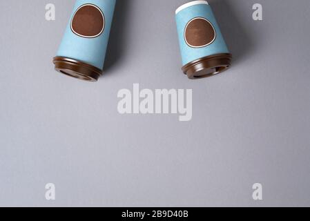 Take away tea or coffee cup on grey background. Top view. Copy space. Minimal composition, layout for design. Coffee concept. Stock Photo