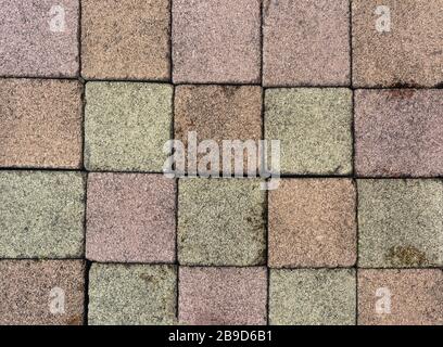 Brick pavement tile, top view. Urban texture as background. Stone pavement texture. Granite cobblestoned pavement background. closeup Stock Photo