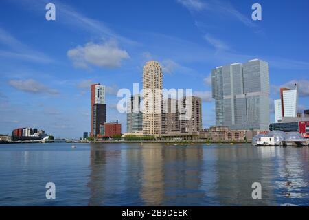 View from Rijnhaven of high rise buildings on Kop van Zuid Rotterdam in sunny weather including floating spheres in the foreground Stock Photo
