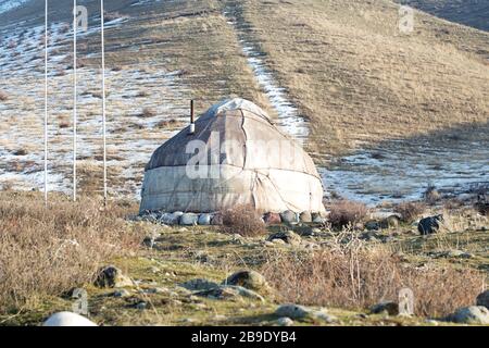 The ancient dwelling of the peoples of Asia is a yurt. In the mountains in winter. snow landscape Stock Photo