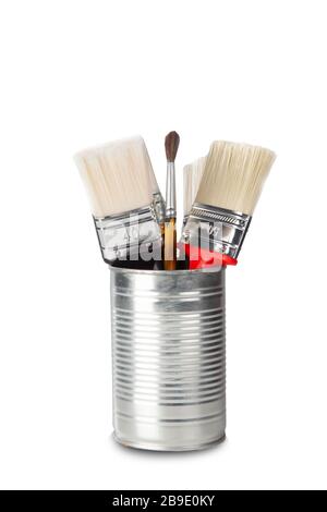 studio shot of brushes of different colors in tin can elaborated on white background with shadow under Stock Photo