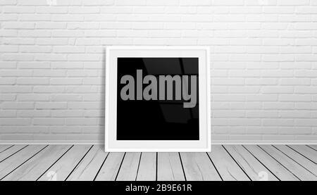 Picture frame mockup. Isolated frame for art, design presentation. Frame leaning on white brick wall. Wooden floor. Stock Photo