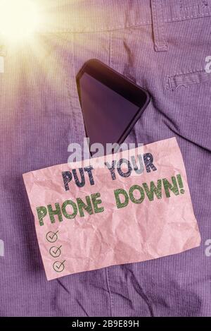 Writing note showing Put Your Phone Down. Business concept for end telephone connection saying goodbye caller Smartphone device inside trousers front Stock Photo